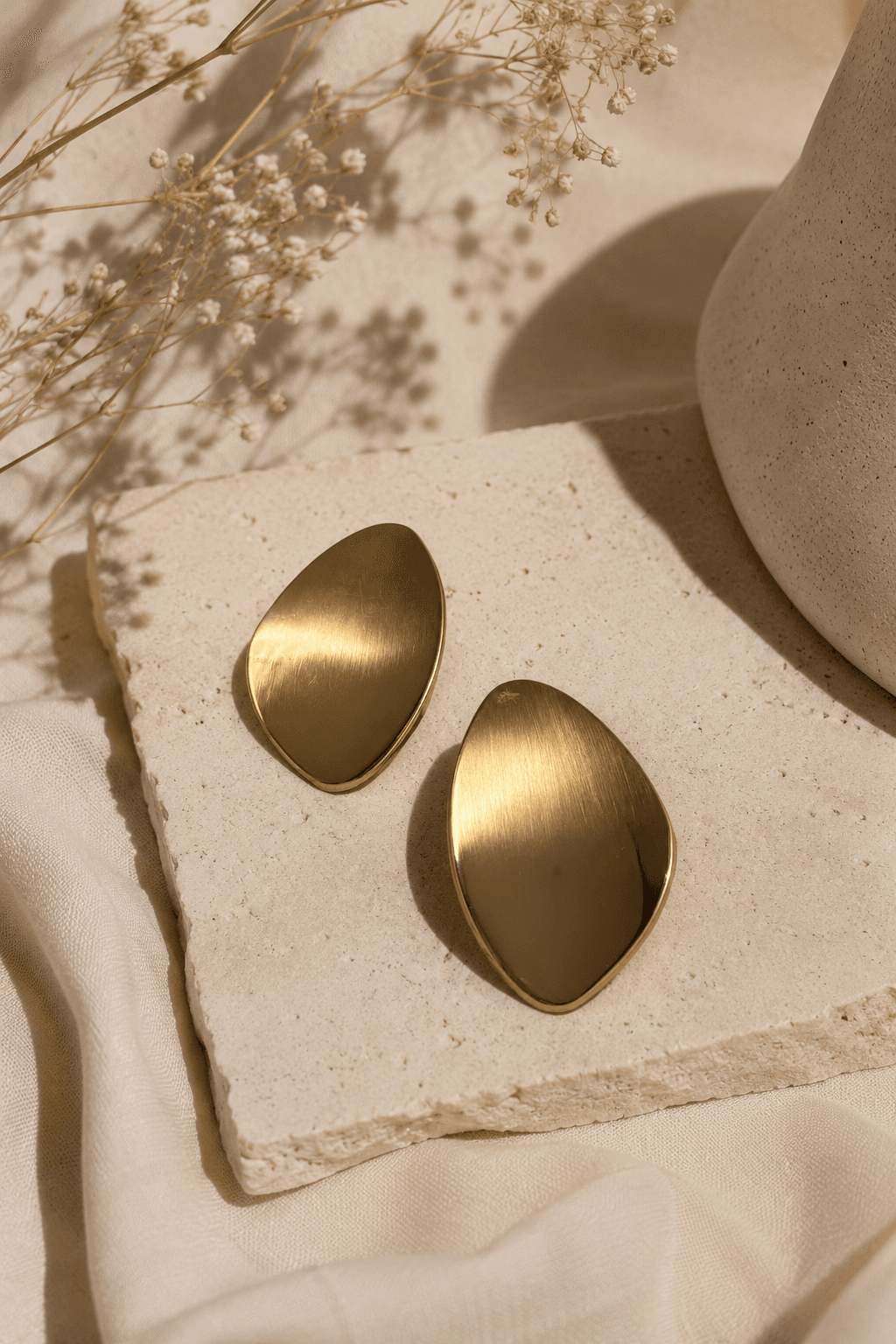 Boucles d'oreilles dorées sur fond neutre